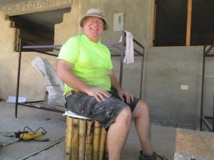 Youthaiti volunteer, Jim Hagen, demonstrating a bucket toilet.